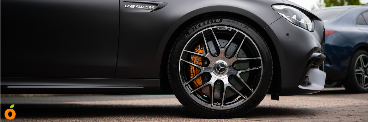 close ups of wheels on a Mercedes-AMG and a McLaren sports car